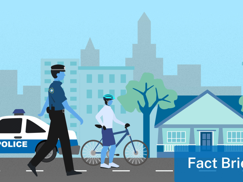 An illustration of a police officer walking down a city street.